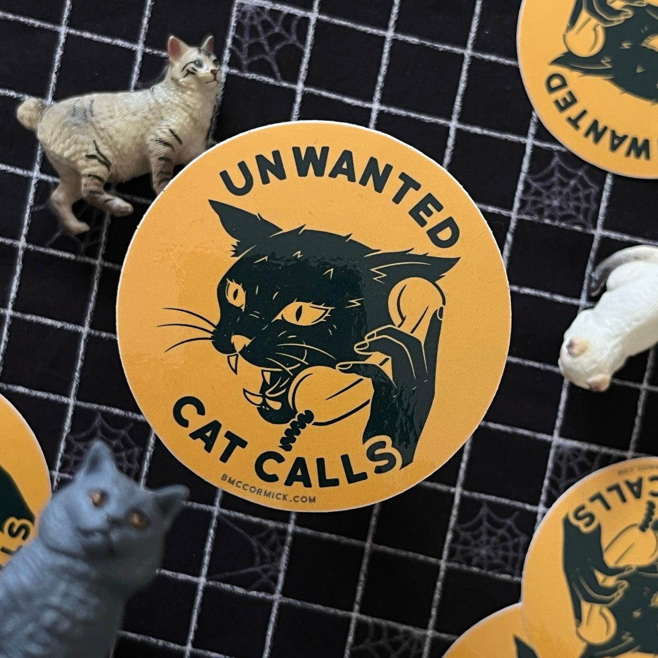 Round sticker with black cat and Unwanted Cat Calls text