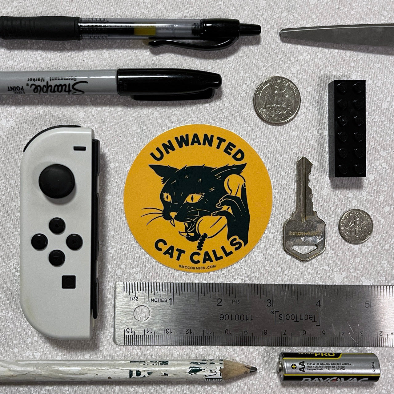 Round sticker with black cat and Unwanted Cat Calls text