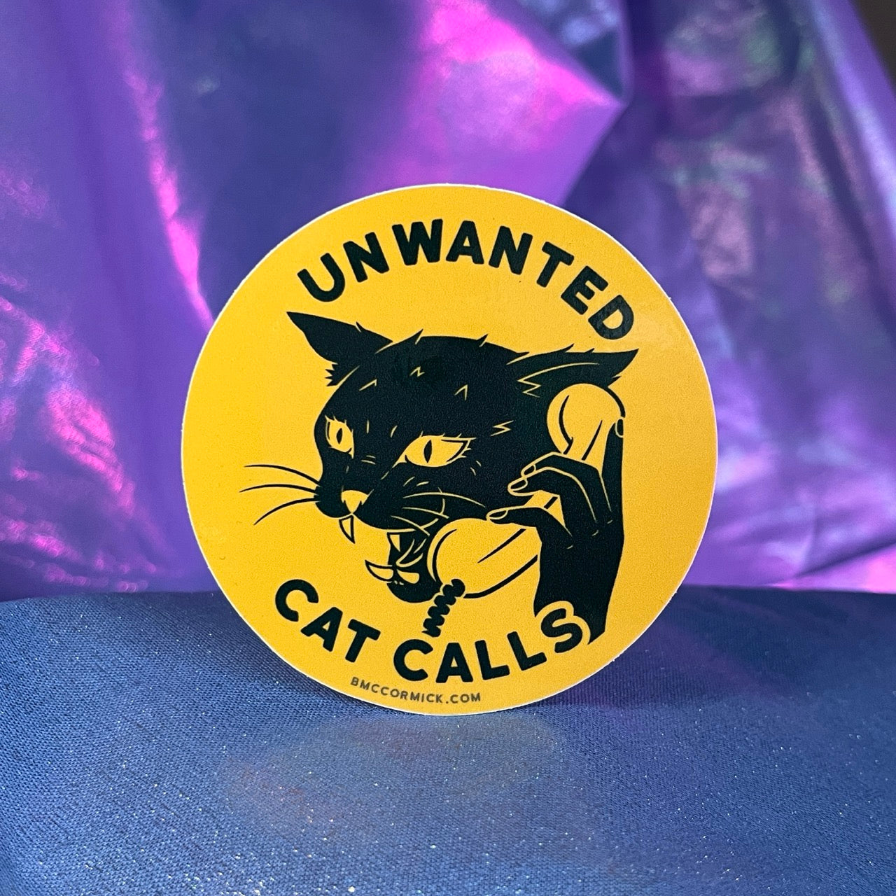 Round sticker with black cat and Unwanted Cat Calls text