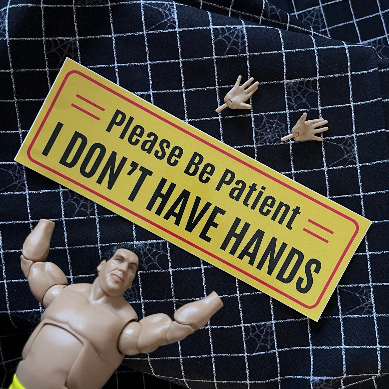 Yellow bumper sticker with Please Be Patient I Don't Have Hands text