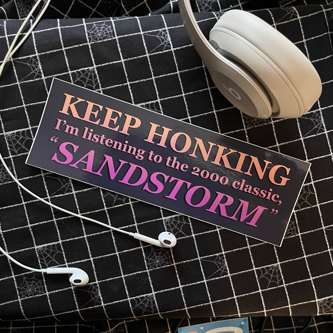 Bumper sticker says Keep Honking I'm Listening to the 2000 Classic, "Sandstorm"